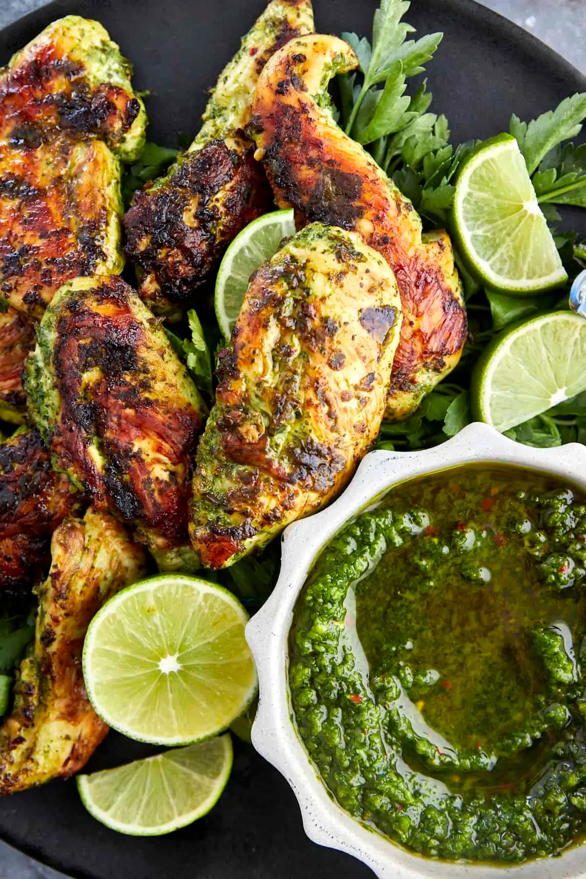 A vibrant, plated serving of Cilantro Lime Chicken garnished with fresh cilantro and lime wedges, styled with natural light