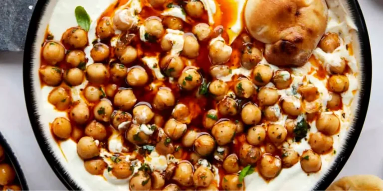 Marinated chickpeas with whipped feta topped with fresh herbs and olive oil